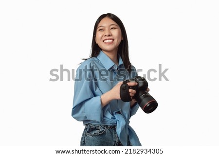 Happy Japanese Photographer Lady Posing Holding Photo Camera Over White Studio Background. Professional Creative Photography Career And Education Concept. Isolated
