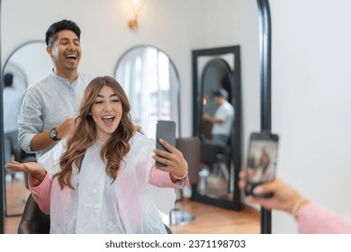 Happy and joyful influencer taking a selfie with a professional hairdresser in a salon - Powered by Shutterstock