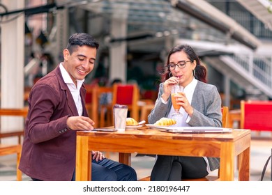 Happy Joyful Latin Young Couple Having Breakfast Together Talking And Enjoying Romantic Date At Cafe Bar Restaurant.