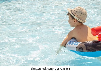 Happy Joyful Little Boy Having Fun In Pool Water.kid Using Inflatable Ring Police Car Shape.swimming Summer Time Sunshine Bright Light Day.travel Tourism S Trip Vacation Family.leisure