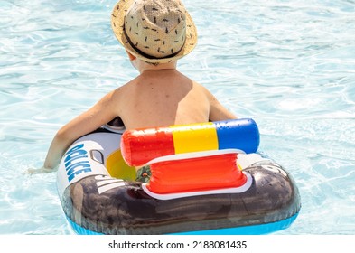 Happy Joyful Little Boy Having Fun In Pool Water.kid Using Inflatable Ring Police Car Shape.swimming Summer Time Sunshine Bright Light Day.travel Tourism S Trip Vacation Family.leisure