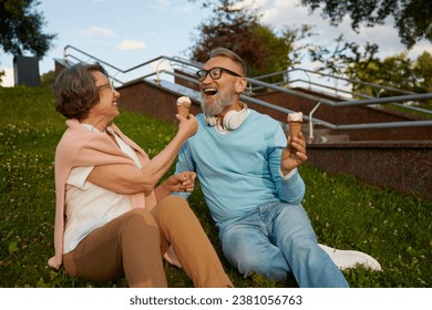 Happy joyful senior couple eating ice-cream in park - Powered by Shutterstock