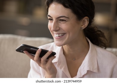 Happy Joyful Smartphone User Woman Giving Commands To Virtual Assistant, Recording Audio Message, Making Call From Home, Talking On Speaker, Using Voice Recognition App