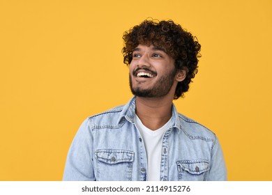 Happy joyful smiling young indian man looking aside up thinking of new good opportunities, dreaming, feeling inspired and proud standing isolated on yellow background. Portrait - Shutterstock ID 2114915276