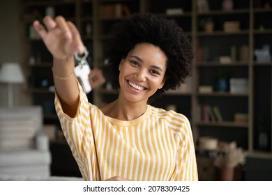 Happy Joyful Young African Woman Showing Keys At Camera. Just Moved Homeowner, Tenant Headshot Portrait. Real Estate Agent, Realtor Offering Property For Rent, Buying, Mortgage. New Home Concept