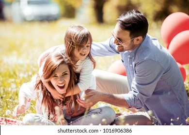 Happy Joyful Young Family Father,mother And Little Daughter Having Fun Outdoors,playing Together In Spring Park. 