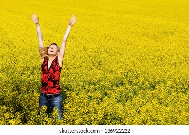Happy jumping girl in the rapeseed field