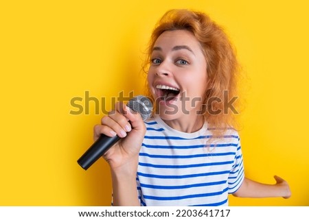 happy karaoke woman singer isolated on yellow background. young singer woman