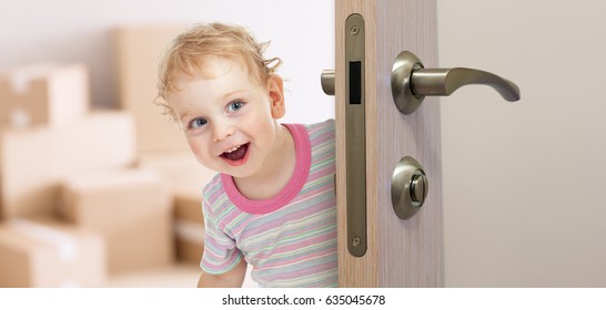 Happy Kid Behind Door In New Room