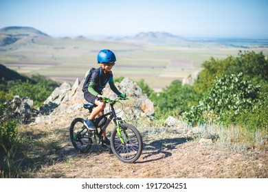 Happy Kid Boy Of 8 Years Having Fun In Summer Park With A Bicycle On Beautiful Fall Day. Active Child Wearing Bike Helmet