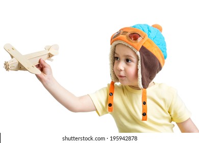 Happy Kid Boy Dressed Pilot And Playing With Wooden Airplane Toy