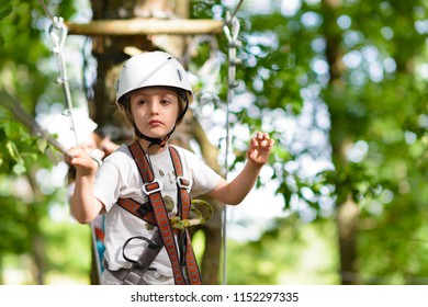 Happy Kid Climbing On High Wire In A Adventure Park