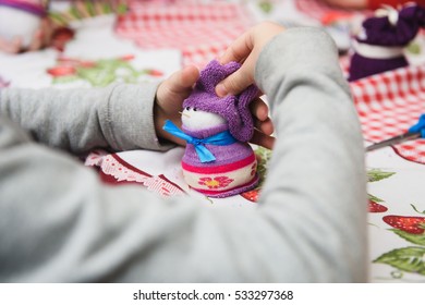 Happy Kid Doing Craft. Small Child Holding A Felt Christmas Snowman In Hands. Workplace In Kindergarten, School Or Home. Kids Christmas Crafts Idea. Children Winter Creativity