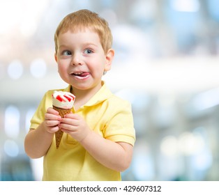 Happy Kid Eating Icecream On Blurred Background