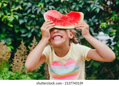 Happy Kid Eating Watermelon And Having Fun Outdoor In Summer Day. Funny Little Girl