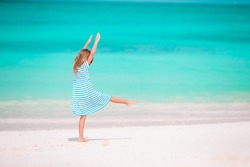 Adorable little girl at beach on her, a Person Photo by travnikovstudio