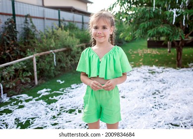 Happy kid enjoying paper show on backyard during outdoor birthday party, social distant celebration at open air in the garden, summer vacation
