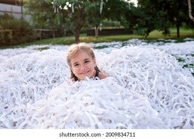 Happy kid enjoying paper show on backyard during outdoor birthday party, social distant celebration at open air in the garden, summer vacation