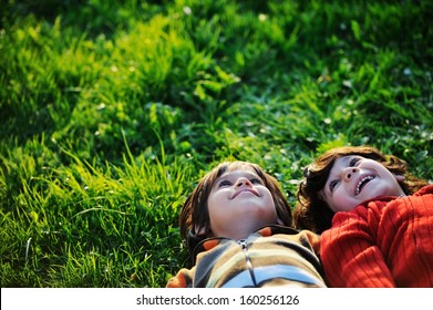 Happy Kid Enjoying Sunny Late Summer And Autumn Day In Nature On Green Grass