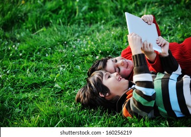 Happy Kid Enjoying Sunny Late Summer And Autumn Day In Nature On Green Grass