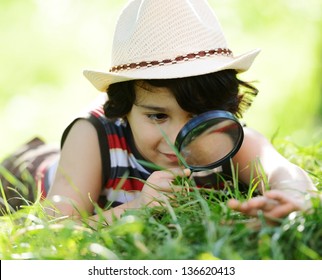 Happy Kid Exploring Nature With Magnifying Glass