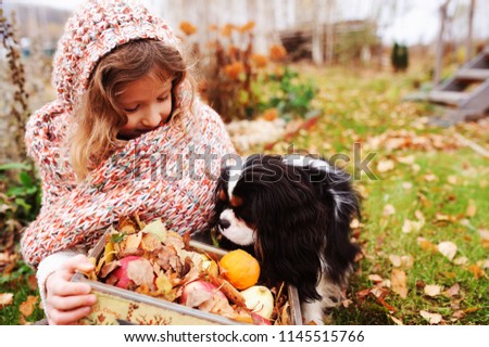 Similar – Foto Bild fröhliches Kind Mädchen mit einem Korb voller Äpfel, das mit ihrem Hund spielt.