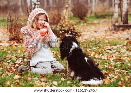 Similar – Foto Bild fröhliches Kind Mädchen mit einem Korb voller Äpfel, das mit ihrem Hund spielt.