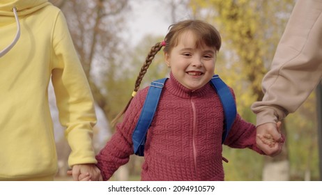 Happy Kid Girl Runs With Her Mother And Father In City Park, Happy Family Life, Cheerful Child With Backpack Rushes To School In Schoolyard, Time To Study And Get An Education, Daughter With Parents