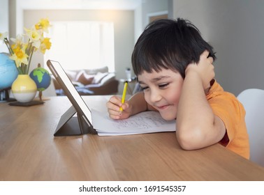 Happy Kid Having Fun Watching Cartoon On Tablet, Child Using Digital Pad Searching The Ideas On Internet For His Drawing Art Homework, Home Schooling, Social Distancing, E-learning Online Education