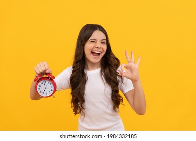 happy kid hold retro alarm clock showing time, ok