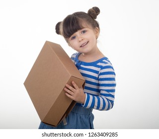 Happy kid holding cardboard boxes, delivery of goods, isolated over white. Internet purchases and e-commerce concept. 