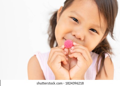 A Happy Kid Holding A Gummy Candy. Children Vitamin.