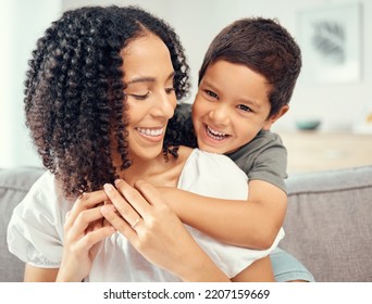 Happy kid hug mom for mothers day, love and care while relaxing together on sofa lounge at home. Boy child playing with smile parent for happiness while bonding, enjoying quality time and fun - Powered by Shutterstock