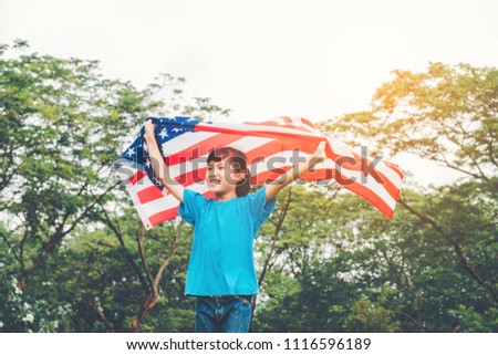 Happy kid little child running with American flag USA celebrate 4th of July