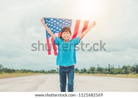 Happy kid little child running with American flag USA celebrate 4th of July