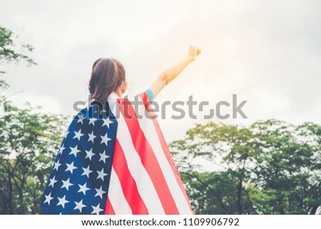 Happy kid little child standing with American flag USA celebrate 4th of July