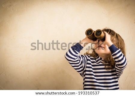 Happy kid looking ahead. Smiling child with spyglass. Travel and adventure concept. Freedom, vacation