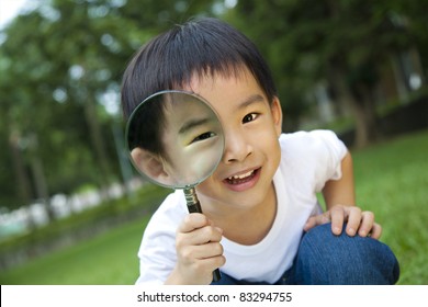happy kid with magnifying glass