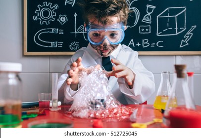 Happy kid making experiments with soap foam
