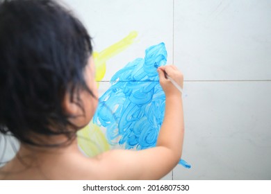 Happy Kid Is Painting In Bathroom