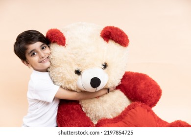 Happy Kid Playing With Big Teddy Bear