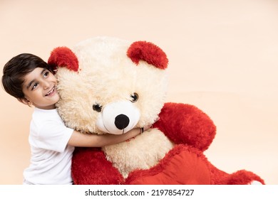 Happy Kid Playing With Big Teddy Bear