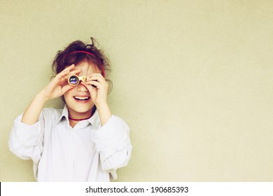 Happy kid playing with binoculars. explore and adventure concept 