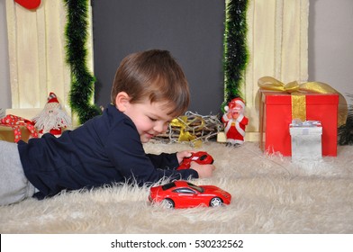 Happy Kid Playing With Car Toy On Remote Control On Christmas Eve 