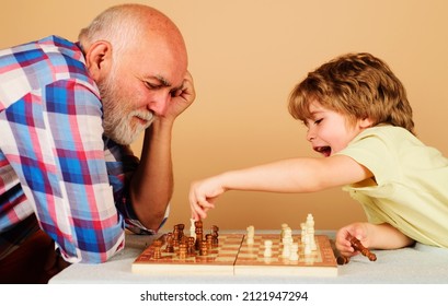 Happy kid playing chess with grandpa. Family relationship with grandfather and grandson. Board game. - Powered by Shutterstock