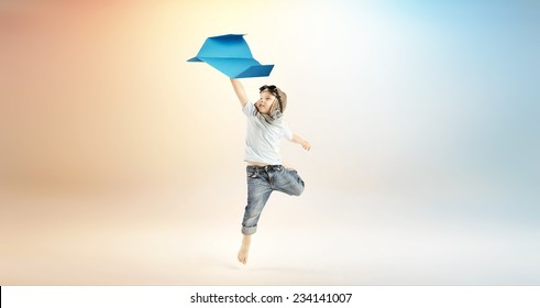 Happy Kid Playing With Paper Airplane