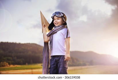 Happy Kid Playing With Paper Airplane