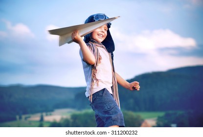 Happy Kid Playing With Paper Airplane