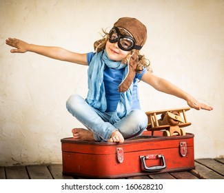 Happy Kid Playing With Toy Airplane