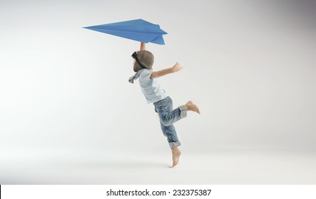 Happy Kid Playing With Toy Airplane